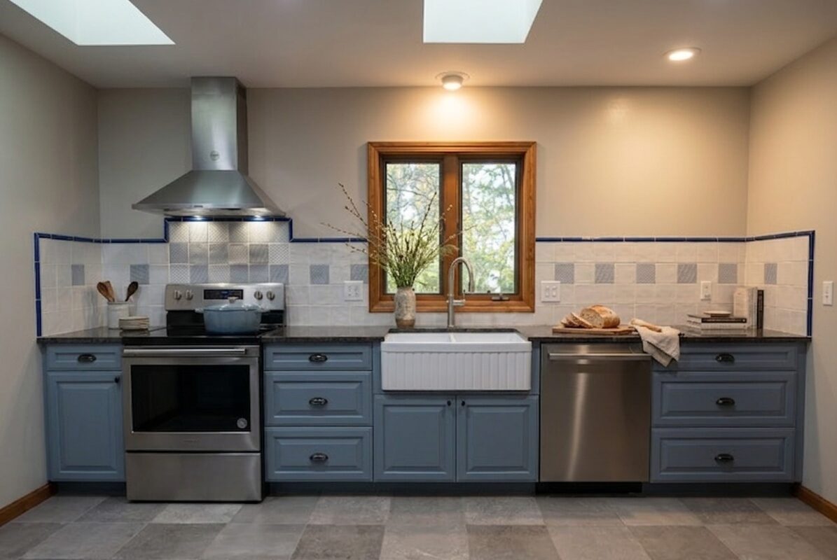 Slate blue kitchen cabinetry with black countertops, Isle La Motte, Vermont